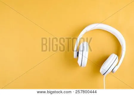 Headphones on an empty yellow desk